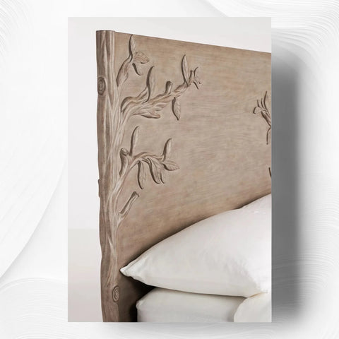 Close-up of hand-carved branch design on brown wood headboard